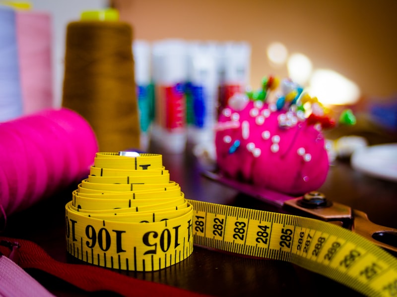 Measuring tape, thread spools, and sewing pins — dress alterations tools